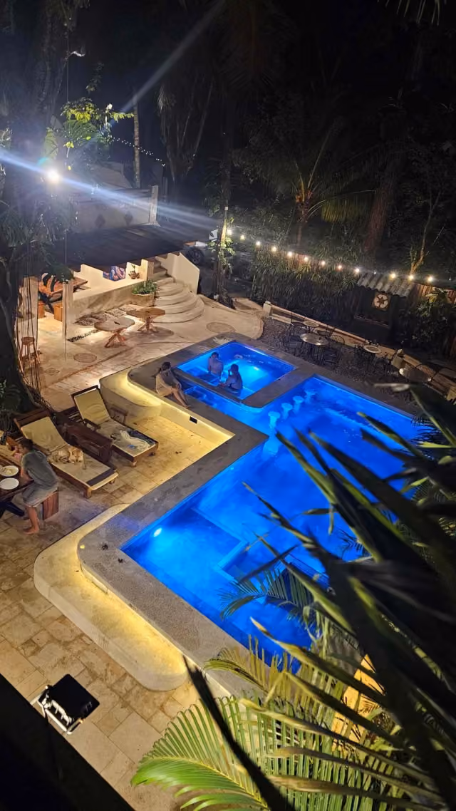 Pool lit up at night with string lights at Dreamcatcher Hotel