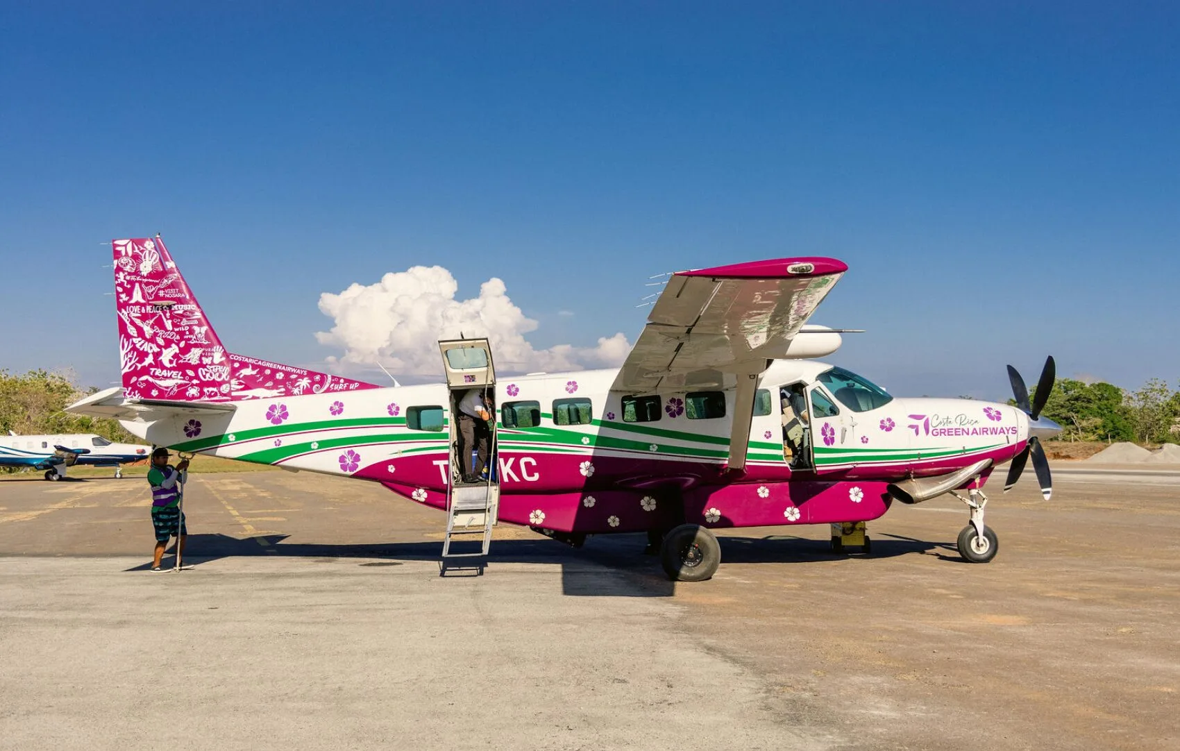 Costa Rica Green Airways aircraft with its floral livery on the tarmac