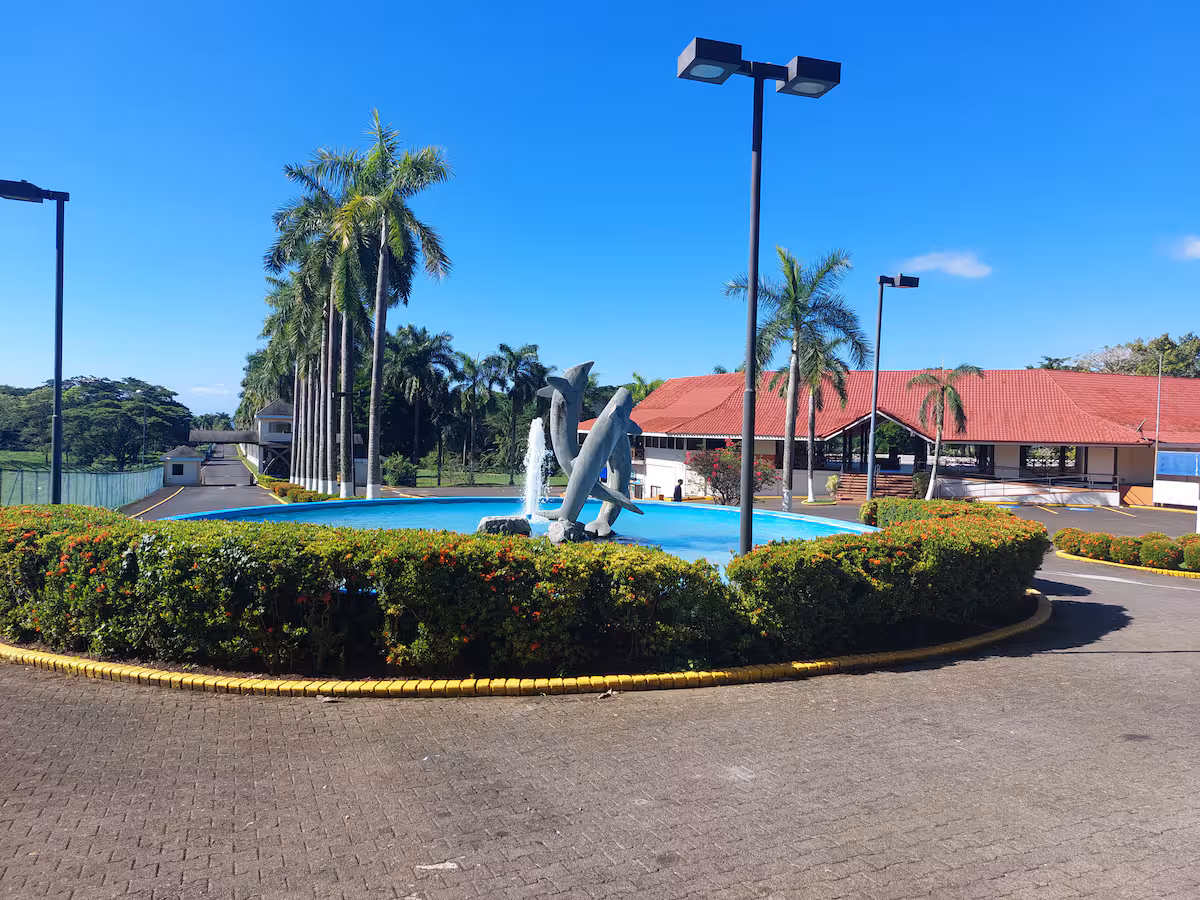 Pool area and clubhouse at Los Delfines Golf & Country Club in Playa Tambor